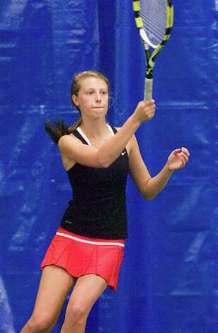 New Canaan's Sara Greene in doubles action as New Canaan High School hosts