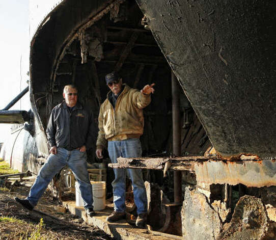 Administrator for the American Undersea Warfare Center, Bradford Gulick, left, and Bob Gawe, a retired volunteer from Western Connecticut, survey the sonar cavity of the bow of the USS Cavalla