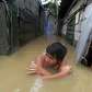 A man wades through flood water in Calumpit, Bulacan, north of.... photo: 1632218 slideshow 31095