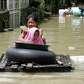Residents use an improvised raft for transport as floodwaters.... photo: 1646478 slideshow 31095