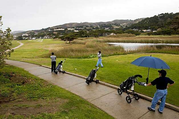 Golfers tee off on the 17th hole as they play golf on the Sharp Park Golf Course November 6, 2009 in Pacifica, Calif.  Photograph by David Paul Morris / Special to the Chronicle Photo: David Paul Morris, The Chronicle