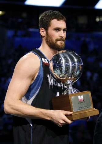 Minnesota Timberwolves' Kevin Love holds the NBA All-Star Three-Point Shootout basketball trophy after winning the event in Orlando, Fla., Saturday, Feb. 25, 2012. (AP Photo/Lynne Sladky) (AP) / SA