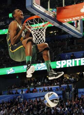 Utah Jazz's Jeremy Evans hangs onto the rim after his attempt during the NBA basketball All-Star Slam Dunk Contest in Orlando, Fla., Saturday, Feb. 25, 2012. Evans earned 29 percent of 3 million text message votes cast by fans to win the competition. (AP Photo/Lynne Sladky) (AP) / SA