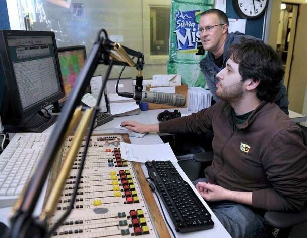 Nate Mumford, right, whose studio name is simply Nate, and Rich Minor, program director and a morning show host, work in the 98Q FM main studio at the radio station Wednesday afternoon.<br /><br />
Photo taken Wednesday, Feb. 29, 2012. Photo: Carol Kaliff / The News-Times