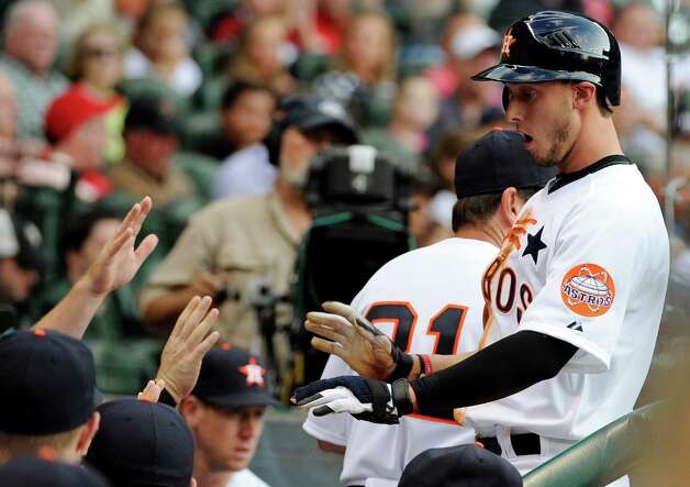 Houston Astros' Jordan Schafer right is greeted in the dugout after 