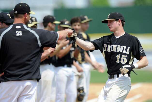 Trumbull's Joey Forren gets a fist bump as his team is introduced during Saturday's FCIAC baseball championship game against Greenwich at the Ballpark at Harbor Yard in Bridgeport on May 26, 2012. Photo: Lindsay Niegelberg / Stamford Advocate