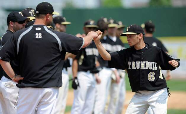Trumbull's Brandon Liscinsky gets a fist bump as his team is introduced during Saturday's FCIAC baseball championship game against Greenwich at the Ballpark at Harbor Yard in Bridgeport on May 26, 2012. Photo: Lindsay Niegelberg / Stamford Advocate