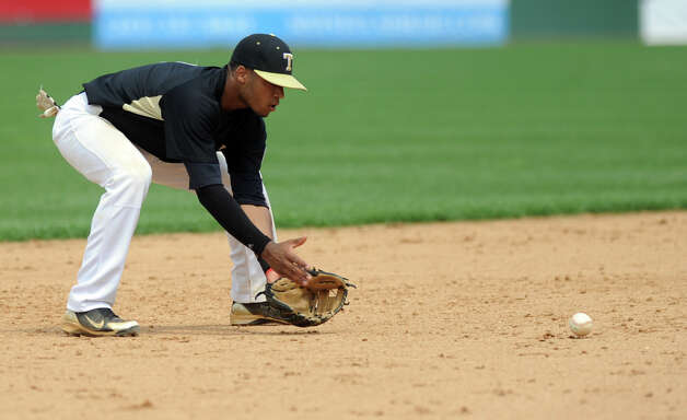 Trumbull's Marcus Jenkins fields a ball during Saturday's FCIAC baseball championship game at the Ballpark at Harbor Yard in Bridgeport on May 26, 2012. Photo: Lindsay Niegelberg / Stamford Advocate