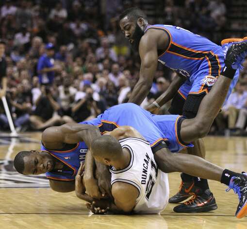 Oklahoma City Thunder's Serge Ibaka (9) fights for control of the ball with San Antonio Spurs' Tim Duncan (21) with Oklahoma City Thunder's James Harden (13) nearby during the first half of game two of the NBA Western Conference Finals in San Antonio, Texas on Tuesday, May 29, 2012. Edward A. Ornelas/Express-News (Edward A. Ornelas / San Antonio Express-News) / SA