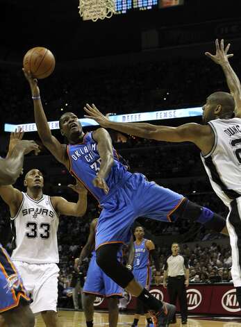 Oklahoma City Thunder's Kevin Durant (35) shoots near San Antonio Spurs' Boris Diaw (33) and San Antonio Spurs' Tim Duncan (21) during the first half of game two of the NBA Western Conference Finals in San Antonio, Texas on Tuesday, May 29, 2012. Kin Man Hui/Express-News (Kin Man Hui / San Antonio Express-News) / SA