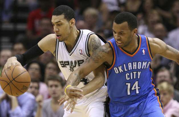 San Antonio Spurs' Danny Green (4) maintains control of the ball against Oklahoma City Thunder's Daequan Cook (14) during the first half of game two of the NBA Western Conference Finals in San Antonio, Texas on Tuesday, May 29, 2012. Edward A. Ornelas/Express-News (Edward A. Ornelas / San Antonio Express-News) / SA