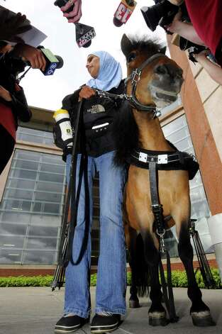 Mona Ramouni, who is blind, talks with local media following her at Albany International Airport with Cali her guide horse in Colonie N.Y. Tuesday June 26, 2012. (Michael P. Farrell/Times Union) Photo: Michael P. Farrell / AL