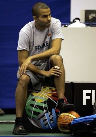 France's star player Tony Parker of the NBA's San Antonio Spurs watches his team's practice session in Sendai, Japan, Friday Aug. 18, 2006. Parker will not play for France in the basketball world championships after being diagnosed with a broken finger. Parker had X-rays of his right index finger in Japan on Thursday and found out Friday that it was broken. (Dusan Vranic / Associated Press) / SA