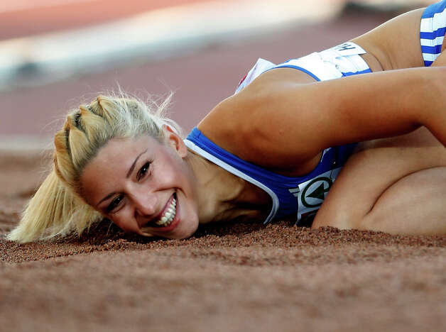 FILE- Greece's Voula Papachristou lands in the sand after her jump at the Women's Triple Jump final at the European Athletics Championships in Helsinki, Finland, in this file photo dated Friday, June 29, 2012. The Hellenic Olympic Committee has removed triple jumper Voula Papachristou from the team taking part in the upcoming London Olympic Games over comments she made on twitter making fun of African immigrants and expressing support for a far-right party. ?The track and field athlete Paraskevi (Voula) Papachristou is placed outside the Olympic Team for statements contrary to the values and ideas of the Olympic movement,? a statement by the Hellenic Olympic Committee says. Papachristou is in Athens, and was to travel to London ?shortly before the track events start,? the announcement says.(AP Photo/Matt Dunham, file) Photo: Matt Dunham, STF / BE
