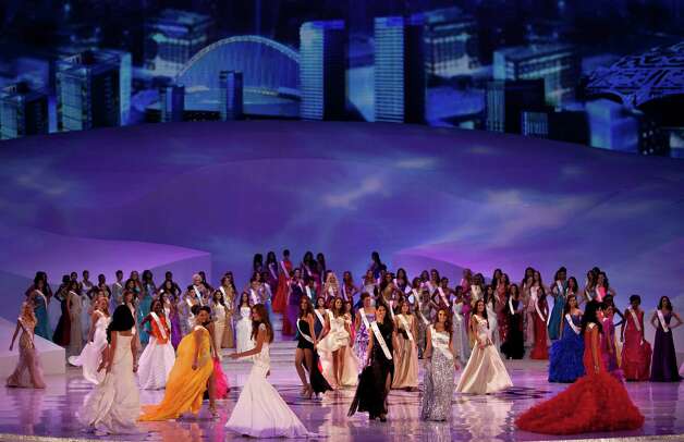 Miss World contestants wearing evening gowns perform on stage. Photo: AP / SL