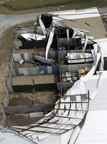 Boats sit in a damage storage building in Reggio, La., in the 