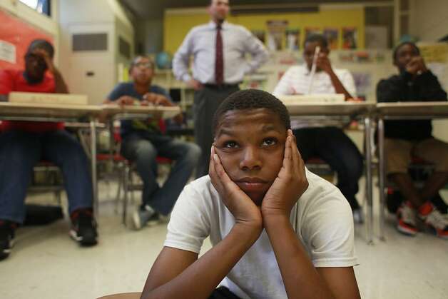 Ahjae Johnson, 12, of Edna Brewer Middle School in Oakland watches his instructor show how to make a drum during manhood development class, which seeks to prevent suspensions by giving students focus. Photo: Mike Kepka, The Chronicle / SF