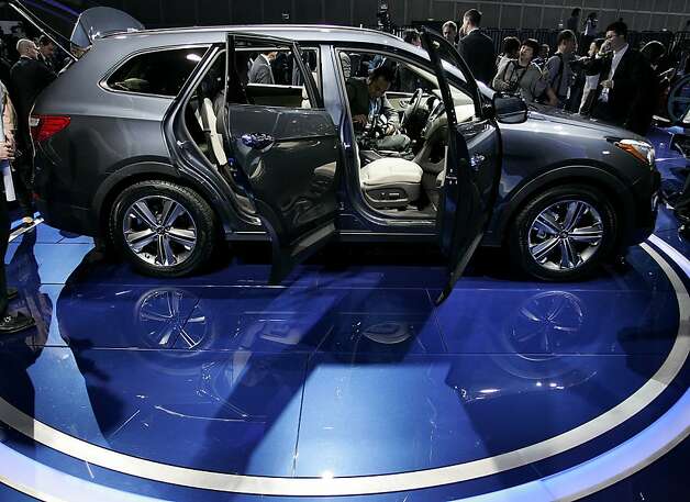 Attendees view the Hyundai Motor Co. Santa Fe during the LA Auto Show in Los Angeles, California, U.S., on Wednesday, Nov. 28, 2012. The LA Auto Show is open to the public Nov. 30 through Dec. 9. Photo: Jonathan Alcorn, Bloomberg / SF