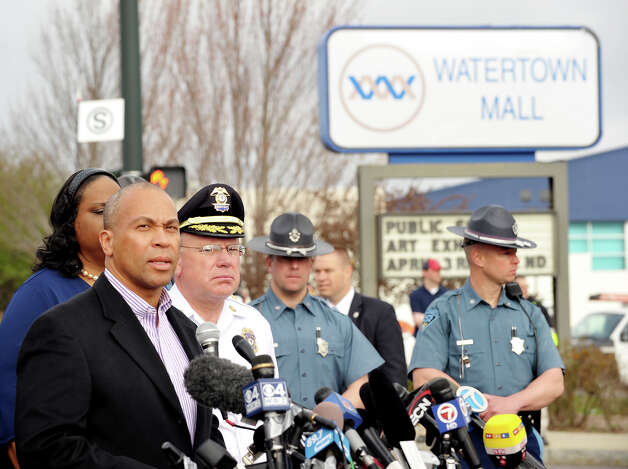 Massachusetts Governor Deval Patrick (L) speaks to the media at a shopping mall on the perimeter of a locked down area as a search for the second of two suspects wanted in the Boston Marathon bombings takes place on April 19, 2013 in Watertown, Massachusetts. AFP PHOTO/Stan HONDA Photo: STAN HONDA, Getty Images / 2013 AFP