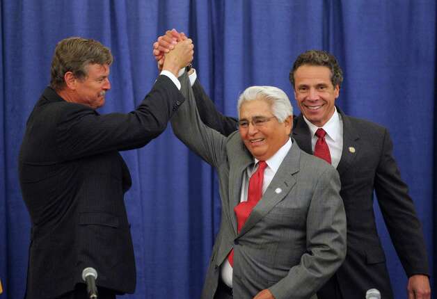 Niagara Falls Mayor Paul Dyster, left, shakes with New York Governor Andrew Cuomo, right, and Seneca Nation President Barry Snyder before they signed an agreement after a long dispute about casino revenue sharing in Niagara Falls, N.Y. Thursday, June 13, 2013.  (AP Photo/The Buffalo News, Mark Mulville) TV OUT; MAGS OUT; MANDATORY CREDIT; BATAVIA DAILY NEWS OUT; DUNKIRK OBSERVER OUT; JAMESTOWN POST-JOURNAL OUT; LOCKPORT UNION-SUN JOURNAL OUT; NIAGARA GAZETTE OUT; OLEAN TIMES-HERALD OUT; SALAMANCA PRESS OUT; TONAWANDA NEWS OUT Photo: MARK MULVILLE