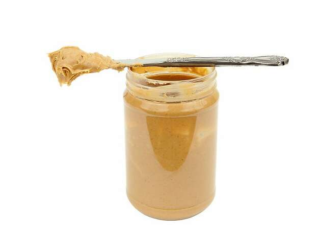 Open jar of peanut butter and knife, ready to spread. Photo: Istockphoto.com Nichols