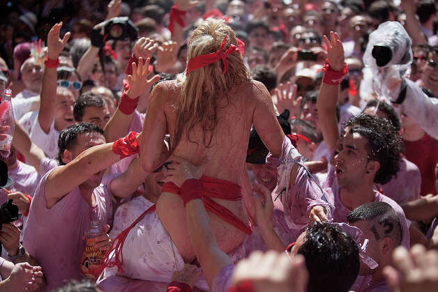 Revellers celebrate during the opening day or 'Chupinazo', of the San Fermin Running of the Bulls fiesta on July 6, 2013 in Pamplona, Spain. The annual Fiesta de San Fermin, made famous by the 1926 novel of US writer Ernest Hemmingway entitled 'The Sun Also Rises,' involves the running of the bulls through the historic heart of Pamplona, this year for nine days from July 6-14. Photo: Pablo Blazquez Dominguez, Getty Images / 2013 Getty Images