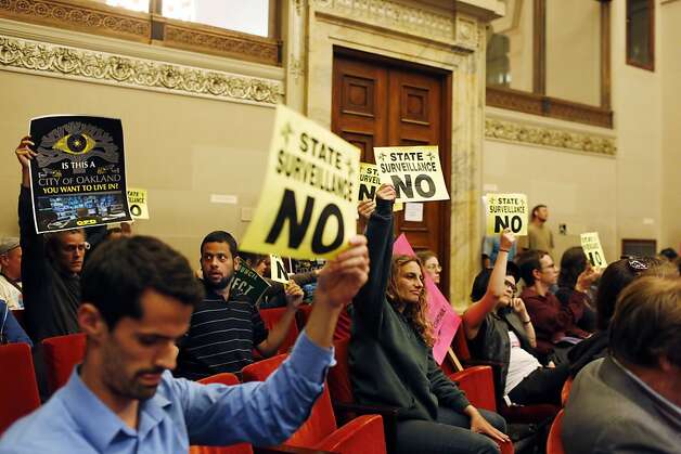 Protestors against the Domain Awareness Center hold up signs during a city council meeting. Photo: Ian C. Bates, The Chronicle