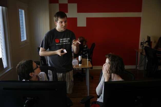 Hackbright Academy students Gosia Migdal (left) and Katie Lefevre get help from instructor Nick Audo as they work on their first day of class. Photo: Lea Suzuki, The Chronicle