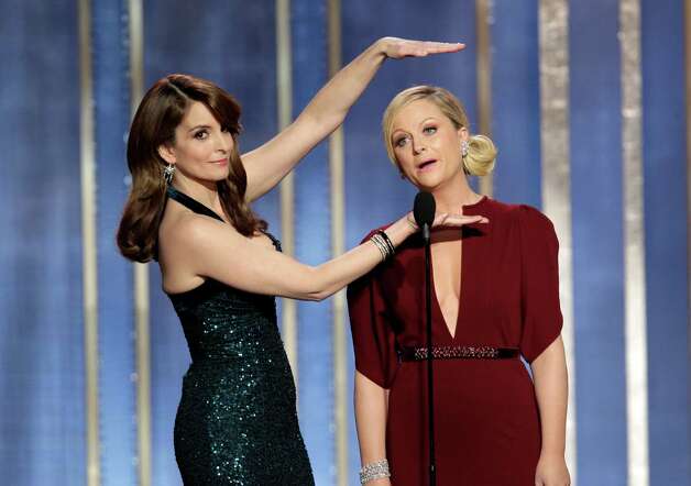 FILE - In this Sunday, Jan. 13, 2013, file photo, provided by NBC, co-hosts Tina Fey, left, and Amy Poehler appear on stage during the annual Golden Globe Awards, at the Beverly Hilton Hotel, in Beverly Hills, Calif. The Hollywood Foreign Press Association said Tuesday, Oct. 15, 2013, that Fey and Poehler have signed up to host the Golden Globes for two more years. (AP Photo/NBC, Paul Drinkwater, File) ORG XMIT: NY118 Photo: Paul Drinkwater / NBC