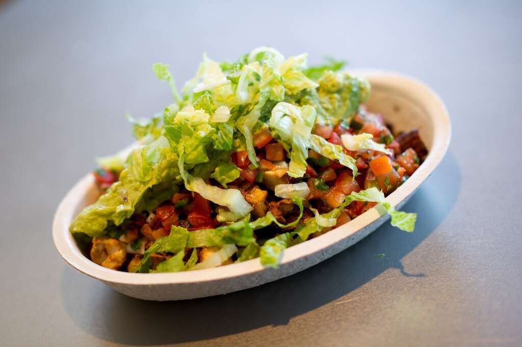 Chipotle — Chicken Burrito Bowl with brown rice and pinto beans, no cheese or sour cream [500 calories)Health Tip: Lose the tortilla, cheese and sour cream. 42 grams of protein 13.5 grams of fat57 grams of carbs 805 milligrams of sodium  Photo: David Paul Morris, Bloomberg
