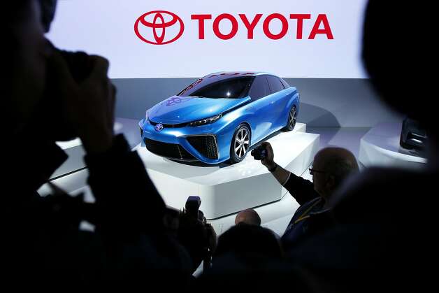 A Toyota Motor Corp. FCV Concept vehicle stands on display while members of the media take photographs at the 43rd Tokyo Motor Show 2013 in Tokyo, Japan, on Wednesday, Nov. 20, 2013. Photo: Kiyoshi Ota, Bloomberg