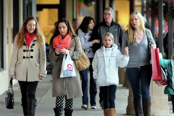 Shoppers walk with their purchases