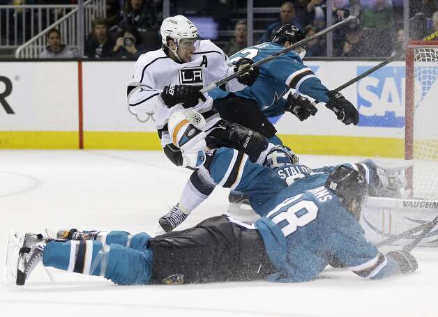 Los Angeles Kings' Anze Kopitar, of Slovenia, top left, trips over San Jose Sharks goalie Alex Stalock as he scores during the second period of an NHL hockey game on Monday, Jan. 27, 2014, in San Jose, Calif. (AP Photo/Marcio Jose Sanchez) Photo: Marcio Jose Sanchez, Associated Press
