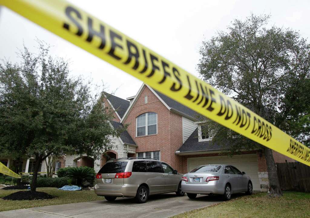 Crime scene tape surrounds a home in the 14000 block of Fosters Creek Dr. Friday, Jan. 31, 2014 in Cypress where four people where found dead inside on Thursday. Photo: Melissa Phillip, Houston Chronicle / © 2014 Houston Chronicle