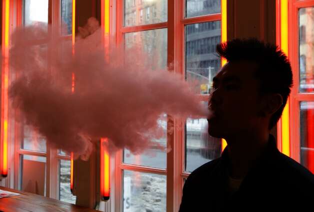 A patron exhales e-cigarette vapor at the Henley Vaporium in New York. Photo: Frank Franklin II, Associated Press