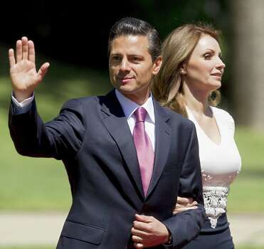 Mexican President Enrique Pena Nieto (L) next to his wife Angelica Rivera waves at the press in Vina Del Mar, Chile on March 11, 2014 after Chilean President Michelle Bachelet's inauguration. Socialist Bachelet took the oath of office as president of Chile Tuesday, returning to power after four years with a reform agenda to reduce social disparities in this prosperous South American countrywave to the press at Cerro Castillo Palace in Vina Del Mar, on March 11, 2014 after Bachelet's inauguration. AFP/Claudio ReyesClaudio Reyes/AFP/Getty Images Photo: CLAUDIO REYES, Stringer / AFP