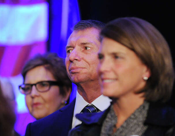 WWE CEO Vince McMahon, center, listens as his wife Republican Linda McMahon gives her concession speech in the race for U.S. Senate on election night at the Hilton Stamford Hotel, Conn.,Tuesday night, November 6, 2012. Photo: Bob Luckey / Greenwich Time