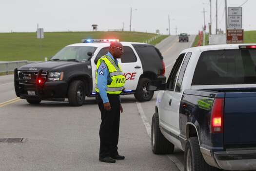 Texas City police Cpl. Mickey House mans a roadblock at the entrance of the Texas City Dike on Sunday, March 23, 2014. (Melissa Phillip / Houston Chronicle)