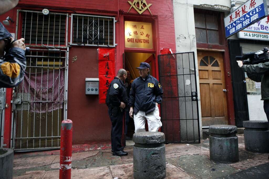 SFPD and FBI agents stand outside the Ghee Kung Tong Chinese Free Masons Temple in Chinatown that was the target of a raid related to Sen. Leland Yee's arrest, San Francisco, CA, Wednesday Mar. 26, 2014.The FBI raids State Sen. Leland Yee's office in Sacramento and other locations were searched by the FBI in San Francisco. He was reportedly arrested on public corruption charges Wednesday morning amid raids of his office in Sacramento and searches by the FBI in San Francisco. Photo: Michael Short, The Chronicle