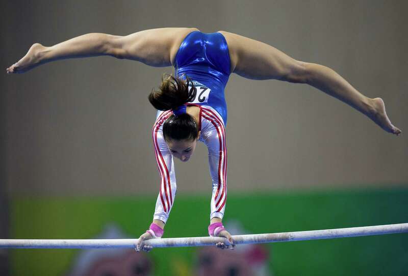 Malaysias FARAH ANN Abdul Hadi competes on the uneven bars during.