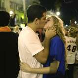 A couple embraces near the intersection of 19th and Mission Street in San Francisco after the Giants win the World Series on Wednesday, October 29, 2014.
