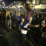 Fans celebrate near the intersection of 19th and Mission Street after the Giants win the World Series on Wednesday, October 29, 2014.