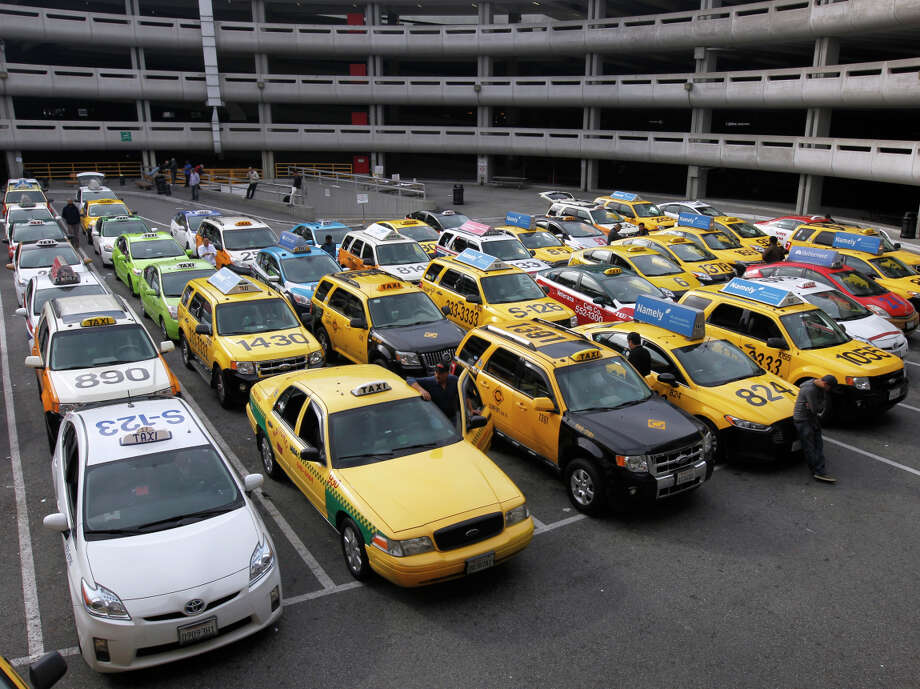 Cabs in a staging area await service at San Francisco International Airport. Photo: Paul Chinn / The Chronicle / ONLINE_YES