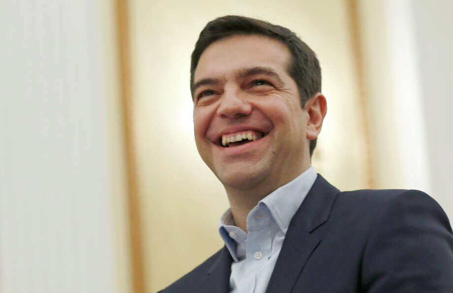 Alexis Tsipras smiles as he is sworn in as prime minister at a ceremony at the - 920x920