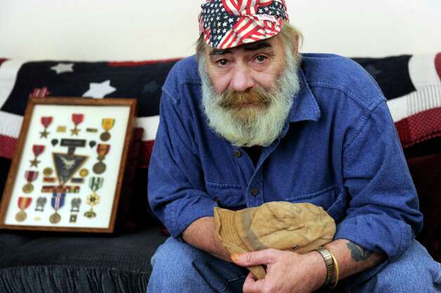 Peter Ballard, 63, a veteran of the war in Vietnam, is photographed in his home in New Fairfield, Conn., Thursday, March 5, 2015. In his hands is the boonie hat that he war during the war. Photo: Carol Kaliff / The News-Times