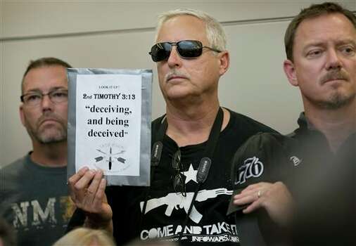 Bob Welch holds a sign at a public hearing about the Jade Helm 15 military training exercise in Bastrop, Texas, Monday April 27, 2015. See the Texas towns that would be impacted by Operation Jade Helm. Photo: Jay Janner, Associated Press / Austin American-Statesman