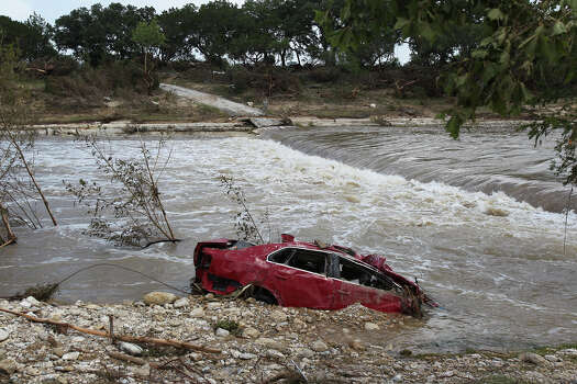 submerged as homeowners clean up on Flite Acres Road along the Blanco ...