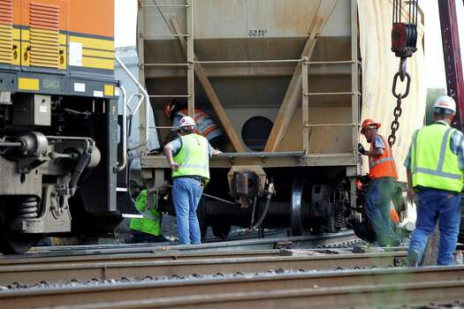 Workers with Union Pacific try to get a derailed train back on its tracks at Harrisburg Boulevard and Hughes Street on Wednesday, June 24, 2015, in Houston. Union Pacific said the locomotive and six rail cars went off the track, but remained upright. The rail company says the rail cars were carrying plastic products and did not spill. Photo: Karen Warren, Houston Chronicle / © 2015 Houston Chronicle