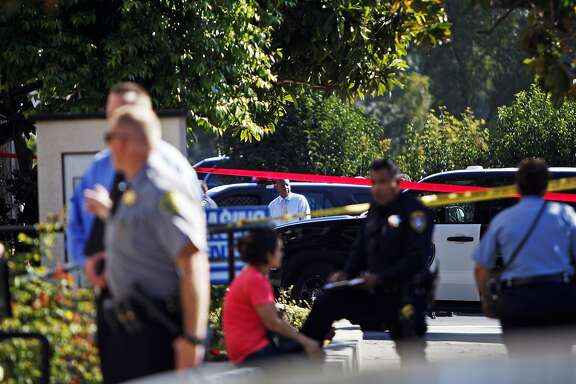 Police are seen at the scene of a police involved shooting at MacArthur Boulevard and Van Buren Avenue in Oakland, Ca. on Thursday, Aug. 27, 2015. The incident left the involved police officer in the hospital and the suspect dead at the scene.