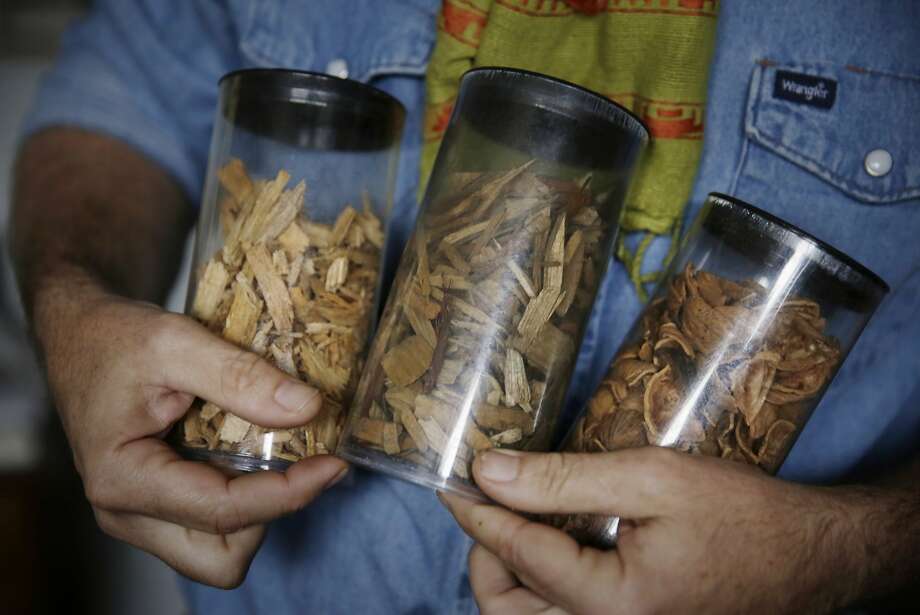 A worker holds samples of woody biomass used in All Power products. Photo: Lea Suzuki, The Chronicle